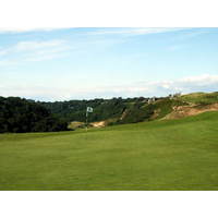 Pennard Golf Club overlooks a valley and old castle ruin.