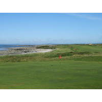 A view of the 18th green and first hole in the background at Royal Porthcawl Golf Club in Wales,