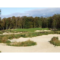 An expanse of sand guards the third green.