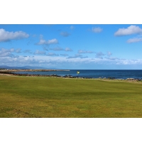 The par-5 ninth hole of the Championship Course at Royal Dornoch Golf Club runs parallel to the Moray Firth. 